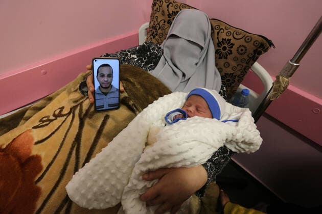 February 18, 2021, khan Younis, Gaza Strip, Palestinian Territory: The wife of the Palestinian prisoner Mohammad al-Qudra, holds her newborn baby, from whom she conceived with sperm smuggled out of an Israeli prison, at Nasser Medical Complex in khan Younis in the southern of Gaza strip on February 18, 2021. Since 2004, Palestinian security prisoners, who are denied conjugal visitations by their wives, have tried to smuggle their sperm out of Israeli prisons, so that their wives can be inseminated in fertility clinics in the West Bank and Ghazza, and bear them children khan Younis Palestinian Territory - ZUMAap3_ 20210218_zaf_ap3_176 Copyright: xAshrafxAmrax