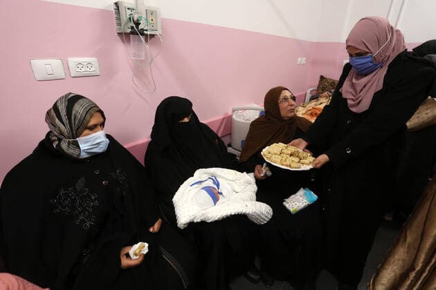 February 18, 2021, khan Younis, Gaza Strip, Palestinian Territory: Relatives of Palestinian prisoner Muhammad al-Qudra celebrate, at Nasser Medical Complex in khan Younis in the southern of Gaza strip on February 18, 2021. Eman al-Qudra gave birth to her newborn in a successful smuggling of sperm to lead to a pregnancy. Since 2004, Palestinian security prisoners, who are denied conjugal visitations by their wives, have tried to smuggle their sperm out of Israeli prisons, so that their wives can be inseminated in fertility clinics in the West Bank and Ghazza, and bear them children khan Younis Palestinian Territory - ZUMAap3_ 20210218_zaf_ap3_186 Copyright: xAshrafxAmrax
