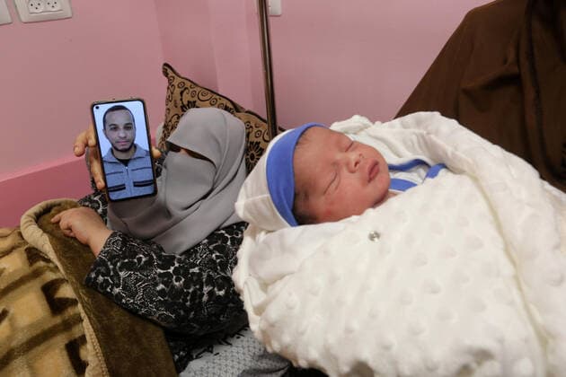 February 18, 2021, khan Younis, Gaza Strip, Palestinian Territory: The wife of the Palestinian prisoner Mohammad al-Qudra displays her husband s picture, who is imprisoned in Israeli prisons, on the mobile phone, at Nasser Medical Complex in khan Younis in the southern of Gaza strip on February 18, 2021. Since 2004, Palestinian security prisoners, who are denied conjugal visitations by their wives, have tried to smuggle their sperm out of Israeli prisons, so that their wives can be inseminated in fertility clinics in the West Bank and Ghazza, and bear them children khan Younis Palestinian Territory - ZUMAap3_ 20210218_zaf_ap3_190 Copyright: xAshrafxAmrax