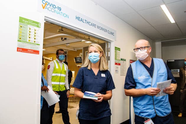 SA COVID19 VACCINE ROLLOUT, Front-line worker CALHN and Medi-hotel Nurse Annabel Thomas (middle) leaves the vaccination room after receiving the Pfizer vaccine at the Royal Adelaide Hospital in Adelaide, Monday, February 22, 2021. Australia will begin its roll out of the Pfizer coronavirus vaccine on Monday, the country s most complicated logistical exercise to date.( NO ARCHIVING, EDITORIAL USE ONLY, NO USE IN BOOKS WITHOUT CONSENT ADELAIDE SA AUSTRALIA Copyright: xMORGANxSETTEx 20210222001522254626