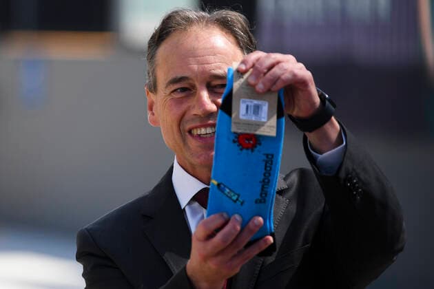 ACT COVID19 VACCINE ROLLOUT, Australian Health Minister Greg Hunt holds up a pair of socks depicting a syringe and a virus after the start of the Biotech Pfizer COVID-19 vaccine rollout at the COVID-19 surge centre in Canberra, Monday, February 22, 2021. Australia will begin its roll out of the Pfizer coronavirus vaccine on Monday, the country s most complicated logistical exercise to date. ( NO ARCHIVING, EDITORIAL USE ONLY, NO USE IN BOOKS WITHOUT CONSENT CANBERRA ACT AUSTRALIA Copyright: xLUKASxCOCHx 20210222001522295296