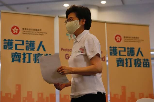 February 22, 2021, HONG KONG, CHINA: HKSAR Chief Executive Carrie Lam walk away smiling after receiving Covid-19 vaccination at the public library as she passing in front of propaganda displays which is written : Protect Yourself and Protect Others, Receive Vaccination Together.Hong Kong government kick started all citizen Covid-19 vaccination program today by letting government high officials to receive the first injections of vaccines.Feb-22,2021Hong Kong.ZUMA HONG KONG CHINA - ZUMAl137 20210222_zap_l137_004 Copyright: xLiauxChung-renx