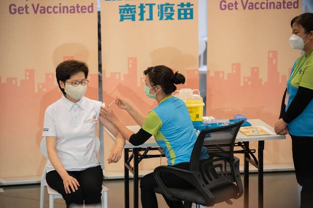 February 22, 2021, Hong Kong, China: Carrie Lam (L), Hong Kong Chief Executive receives a dose of the COVID-19 vaccine at the Community Vaccination Centre at the Hong Kong Central Library..Hong Kong Chief Executive Carrie Lam and members of her cabinet receive their first dose of of the COVID-19 vaccine in a bid to boost public confidence to the vaccine as the vaccination program for the public will begin on 26th February. Hong Kong China - ZUMAs197 20210222_zaa_s197_004 Copyright: xGeovienxSox