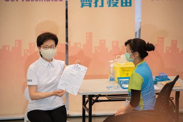 February 22, 2021, Hong Kong, China: Carrie Lam (L), Hong Kong Chief Executive displays her vaccination record to the media at the Community Vaccination Centre at the Hong Kong Central Library after receiving a dose of the COVID-19 vaccine,.Hong Kong Chief Executive Carrie Lam and members of her cabinet receive their first dose of of the COVID-19 vaccine in a bid to boost public confidence to the vaccine as the vaccination program for the public will begin on 26th February. Hong Kong China - ZUMAs197 20210222_zaa_s197_006 Copyright: xGeovienxSox