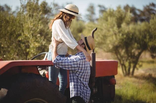 Young couple looking at each other while standing by tractor Young couple looking at each other while standing by tractor at olive farm, model released, , property released, Cape Town, South Africa, 22.03.2017, 1008932.jpg, couple, looking, standing, tractor, olive farm, farm, lifestyle, leisure, casual, white, checked pattern, girlfriend, boyfriend, sun hat, protection, safety, holding, heterosexual couple, together, bonding, love, tree, nature, joy, fun, sunlight, land vehicle, agricultural machinery 30s, Mid Adult, Woman, Female, Hispanic, 20s, Young Adult, Man, Male, Caucasian, 30-34 Years, Mid Adult Women, Hispanic Ethnicity, 25-29 Years, Young Men, Caucasian Ethnicity Outdoors,Side view,Focus on Foreground,Day