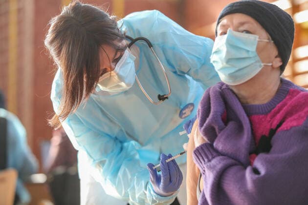 Vaccination in Zagreb, Croatia A woman receive coronavirus disease (COVID-19) vaccine during a mass vaccination in Zagreb, Croatia on February 23, 2021. SanjinxStrukic PIXSELL