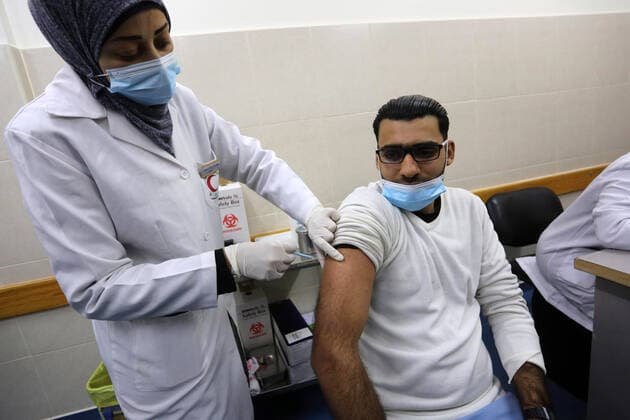 February 23, 2021, Khan Yunis, Gaza Strip, Palestinian Territory: A Palestinian health worker administers a dose of the Russian Sputnik V coronavirus vaccine to a man, at European Hospital, in Khan Yunis, in the southern Gaza Strip on February 23, 2021. Around 20,000 coronavirus vaccine doses from the UAE arrived in Gaza, a delivery reportedly orchestrated by a rival of Palestinian president Mahmud Abbas three months before scheduled Palestinian elections Khan Yunis Palestinian Territory - ZUMAap3_ 20210223_zaf_ap3_046 Copyright: xAshrafxAmrax