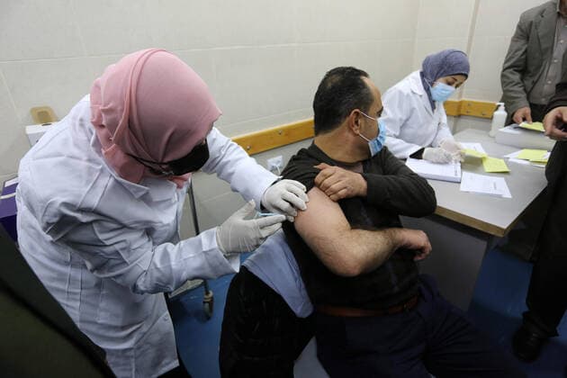 February 23, 2021, Khan Yunis, Gaza Strip, Palestinian Territory: A Palestinian health worker administers a dose of the Russian Sputnik V coronavirus vaccine to a man, at European Hospital, in Khan Yunis, in the southern Gaza Strip on February 23, 2021. Around 20,000 coronavirus vaccine doses from the UAE arrived in Gaza, a delivery reportedly orchestrated by a rival of Palestinian president Mahmud Abbas three months before scheduled Palestinian elections Khan Yunis Palestinian Territory - ZUMAap3_ 20210223_zaf_ap3_054 Copyright: xAshrafxAmrax