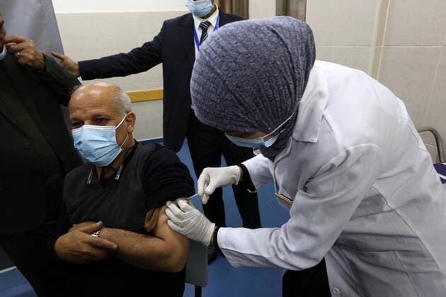 February 23, 2021, Khan Yunis, Gaza Strip, Palestinian Territory: A Palestinian health worker administers a dose of the Russian Sputnik V coronavirus vaccine to a man, at European Hospital, in Khan Yunis, in the southern Gaza Strip on February 23, 2021. Around 20,000 coronavirus vaccine doses from the UAE arrived in Gaza, a delivery reportedly orchestrated by a rival of Palestinian president Mahmud Abbas three months before scheduled Palestinian elections Khan Yunis Palestinian Territory - ZUMAap3_ 20210223_zaf_ap3_055 Copyright: xAshrafxAmrax