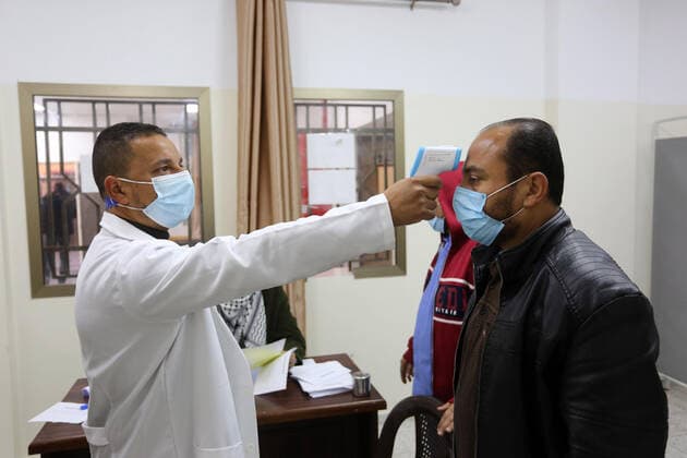February 23, 2021, Khan Yunis, Gaza Strip, Palestinian Territory: A Palestinian health worker administers a dose of the Russian Sputnik V coronavirus vaccine to a man, at European Hospital, in Khan Yunis, in the southern Gaza Strip on February 23, 2021. Around 20,000 coronavirus vaccine doses from the UAE arrived in Gaza, a delivery reportedly orchestrated by a rival of Palestinian president Mahmud Abbas three months before scheduled Palestinian elections Khan Yunis Palestinian Territory - ZUMAap3_ 20210223_zaf_ap3_058 Copyright: xAshrafxAmrax