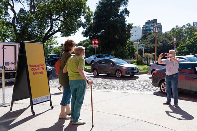 February 23, 2021, City of Buenos Aires, City of Buenos Aires, Argentina: INT. WorldNews. COVID-19. February 23, 2021. City of Buenos Aires, Argentina.-.A woman over 80 years old, with her companion, are taken a picture, outside a temporary vaccination center, after the old lady has just received the vaccinated for SARS CoV2 (COVID-19) on Feb 23, 2021, at Centro Cultural Recoleta, City of Buenos Aires, Argentina..Adults over 80 years old are being vaccinated for SARS CoV2 (COVID-19) since Feb 22, 2021 in City of Buenos Aires, Argentina. City of Buenos Aires Argentina - ZUMAf135 20210223_zap_f135_002 Copyright: xJulietaxFerrariox