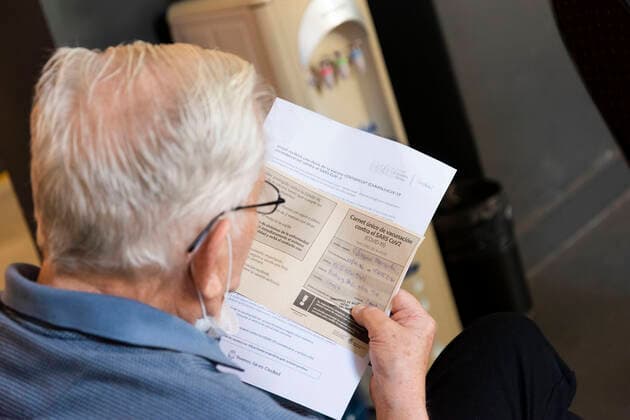 February 23, 2021, City of Buenos Aires, City of Buenos Aires, Argentina: INT. WorldNews. COVID-19. February 23, 2021. City of Buenos Aires, Argentina.- An old man reads his vaccine certificate for SARS CoV2 (COVID-19) on Feb 23, 2021, at a temporary Vaccination Center at Centro Cultural Recoleta, City of Buenos Aires, Argentina. Adults over 80 years old are being vaccinated for SARS CoV2 (COVID-19) since Feb 22, 2021 in City of Buenos Aires, Argentina. City of Buenos Aires Argentina - ZUMAf135 20210223_zap_f135_007 Copyright: xJulietaxFerrariox