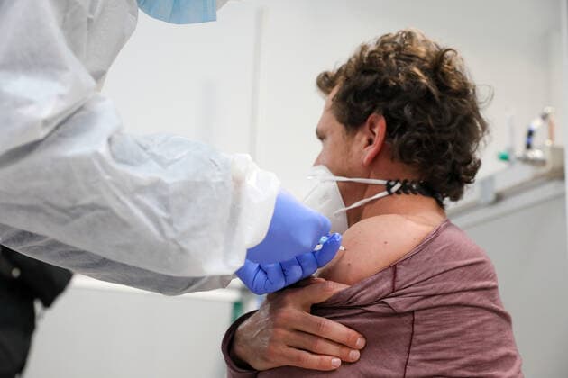 A man receives the AstraZeneca vaccine against COVID-19, in Pavilion 3 of the Public Hospital Enfermera Isabel Zendal, in Madrid, (Spain), on February 23, 2021. This Tuesday begins the vaccination in the pavilion 3 of the hospital with the vaccine of AstraZeneca to 400 people of External Health, AENA, inspectors of Public Health, of Institute of Social Security, professionals of reformatories, Forensic Doctors, Students of CC Health and veterinarians. These new groups to be vaccinated will be joined by those over 80 years of age on Thursday 25 February in the Primary Care centres of each of the health areas of the community with 50,000 doses. 23 FEBRUARY 2021;ISABEL DÃAZ AYUSO;AYUSO;MADRID;COMMUNITY OF MADRID;ZENDAL LagenciaEP PRESS M.FERN Copyright: xLagenciaEPxPRESS M.FERNÃNDEZ.xPOOLx 3576568