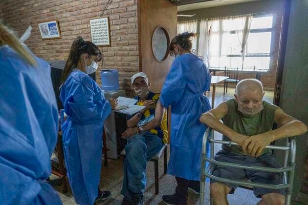 February 25, 2021, Firmat, Santa Fe, Argentina: A nurse applies a shot of India s Serum Institute Covishield vaccine against COVID-19 to and elderly man inside a makeshift care home functioning in a special school. The original care home inside San Martin Hospital was converted into the COVID-19 sector at the beginning of the pandemic, and the residents were moved into this location. Firmat Argentina - ZUMAm105 20210225_zaf_m105_003 Copyright: xPatricioxMurphyx