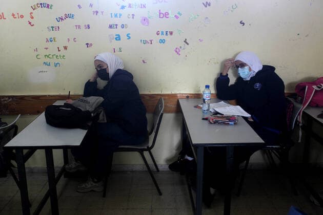 February 27, 2021, Gaza city, Gaza Strip, Palestinian Territory: Palestinian students wearing protective face masks, sit in a classroom, in the morning of the first day of the second semester study, amid the coronavirus disease (COVID-19) outbreak, at their school, in Gaza city, on February 27, 2021 Gaza city Palestinian Territory - ZUMAap3_ 20210227_zaf_ap3_031 Copyright: xMahmoudxAjjourx