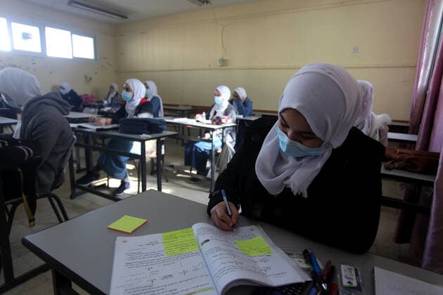February 27, 2021, Gaza city, Gaza Strip, Palestinian Territory: Palestinian students wearing protective face masks, sit in a classroom, in the morning of the first day of the second semester study, amid the coronavirus disease (COVID-19) outbreak, at their school, in Gaza city, on February 27, 2021 Gaza city Palestinian Territory - ZUMAap3_ 20210227_zaf_ap3_040 Copyright: xMahmoudxAjjourx