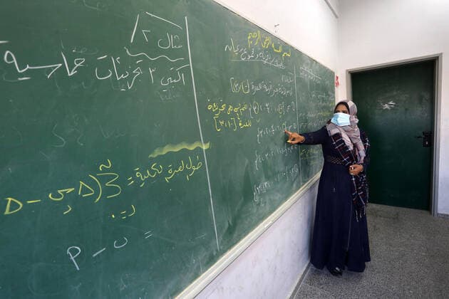 February 27, 2021, Gaza city, Gaza Strip, Palestinian Territory: Palestinian students wearing protective face masks, sit in a classroom, in the morning of the first day of the second semester study, amid the coronavirus disease (COVID-19) outbreak, at their school, in Dair Al Balah in the central of Gaza Strip, on February 27, 2021 Gaza city Palestinian Territory - ZUMAap3_ 20210227_zaf_ap3_090 Copyright: xAshrafxAmrax