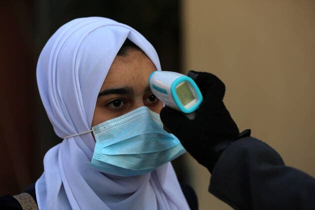 February 27, 2021, Gaza city, Gaza Strip, Palestinian Territory: Palestinian students wearing protective face masks, return back to their school, in the morning of the first day of the second semester study, amid the coronavirus disease (COVID-19) outbreak, in Dair Al Balah in the central of Gaza Strip, on February 27, 2021 Gaza city Palestinian Territory - ZUMAap3_ 20210227_zaf_ap3_101 Copyright: xAshrafxAmrax