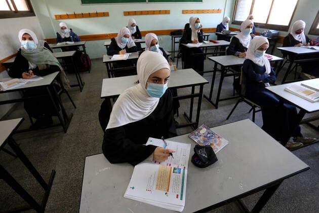 February 27, 2021, Gaza city, Gaza Strip, Palestinian Territory: Palestinian students wearing protective face masks, sit in a classroom, in the morning of the first day of the second semester study, amid the coronavirus disease (COVID-19) outbreak, at their school, in Dair Al Balah in the central of Gaza Strip, on February 27, 2021 Gaza city Palestinian Territory - ZUMAap3_ 20210227_zaf_ap3_106 Copyright: xAshrafxAmrax