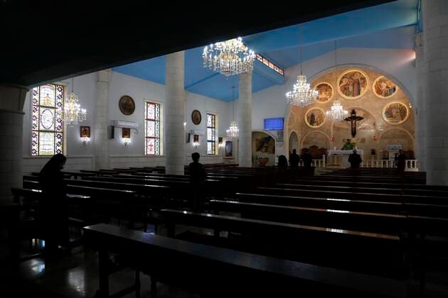 February 28, 2021, Jenin, West Bank, Palestinian Territory: Christian worshippers pray inside Church, amid the coronavirus lockdown in the town of Zababdeh, south of Jenin, in the West Bank on February 28, 2021. Prime Minister Mohammad Shtayyeh announced a new set of restrictions in response to a recent surge in coronavirus infections, including of British and South African mutants, in Palestine.A lockdown of all public and private schools for all classes, except for high school students for a period of 12 days, including kindergartens..A lockdown of all universities, educational and vocational institutes and shifting to distance e-learning programs. A maximum of 50 percent of administrative staff are allowed access to universities..Movemen - ZUMAap3_ 20210228_zaf_ap3_036 Copyright: xOdayxDaibesx