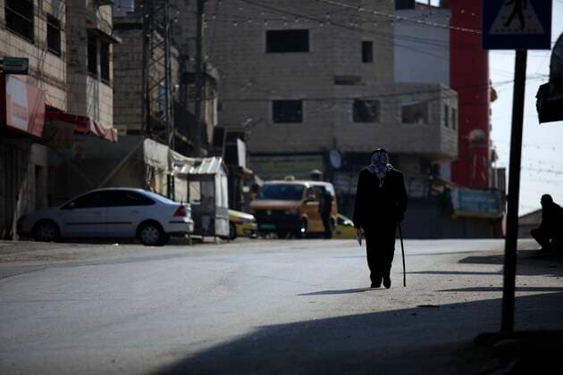 February 28, 2021, Jenin, West Bank, Palestinian Territory: A man walks on an empty street, amid the coronavirus lockdown in the town of Zababdeh, south of Jenin, in the West Bank on February 28, 2021. Prime Minister Mohammad Shtayyeh announced a new set of restrictions in response to a recent surge in coronavirus infections, including of British and South African mutants, in Palestine.A lockdown of all public and private schools for all classes, except for high school students for a period of 12 days, including kindergartens..A lockdown of all universities, educational and vocational institutes and shifting to distance e-learning programs. A maximum of 50 percent of administrative staff are allowed access to universities..Movement between - ZUMAap3_ 20210228_zaf_ap3_049 Copyright: xOdayxDaibesx