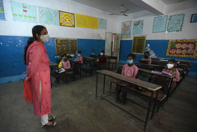 NOIDA, INDIA - MARCH 1: Students of junior wing attending classes on the first day of school as they reopen after almost a year, at Adarsh primary school sector 12 on March 1, 2021 in Noida, India. Nearly a year after the Centre imposed a nationwide lockdown due to the COVID-19 outbreak, several states and UTs have decided to reopen schools and colleges from March 1. As the deadly virus cases are now steadily dropping, the offline classes are going to resume in states such as Bihar, Meghalaya, Jammu and Kashmir, Haryana, among others. (Photo by Sunil Ghosh Hindustan Times) Primary Schools Reopen For The First Time Since Lockdown Due To Covid-19