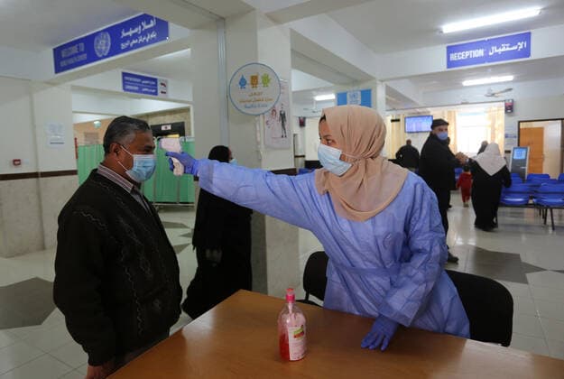 March 6, 2021, Bureij, Gaza Strip, Palestinian Territory: UNRWA employees wear face masks as the provide services in a UN clinic, in Al-Bureij camp in the central Gaza Strip, on March 6, 2021. UNRWA said that this year, the Agency will support approximately 1.25 million food-insecure Palestine refugees in the oPt through emergency food aid or cash assistance. Cash-for-work opportunities will help mitigate substantial loss of livelihoods, specifically in Gaza, and emergency education support will benefit more than 330,000 UNRWA students across the oPt Bureij Palestinian Territory - ZUMAap3_ 20210306_zaf_ap3_128 Copyright: xAshrafxAmrax