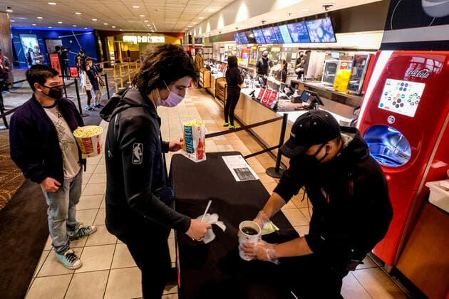 March 15, 2021, Los Angeles, California, USA: Moviegoers wait in line to buy food and drinks at the AMC Theater on the first day of reopened theaters after being closed due to the COVID-19 pandemic in Burbank, California, on March 15, 2021. Los Angeles County restaurants can again welcome customers indoors, and movie theaters and fitness centers are able to reopen, all at limited capacity, with the county advancing today to the less-restrictive red tier of the state s Blueprint for a Safer Economy. Los Angeles USA - ZUMAc68_ 20210315_zaf_c68_011 Copyright: xRingoxChiux