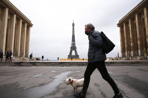 (210317) -- PARIS, March 17, 2021 -- A man walking his dog passes by the Trocadero Place near the Eiffel Tower in Paris, France, March 17, 2021. France has entered a form of third wave (of the coronavirus pandemic) characterized by numerous virus variants, Prime Minister Jean Castex said on Tuesday, stressing that his government still considers vaccination a top priority of its strategy to stem the spread of the virus. On Tuesday, the health authorities reported 29,975 new infections across the country, bringing the cumulative total to 4,108,108. The number of single-day deaths jumped to 408, taking the total to 91,170. ) FRANCE-PARIS-COVID-19-THIRD WAVE GaoxJing