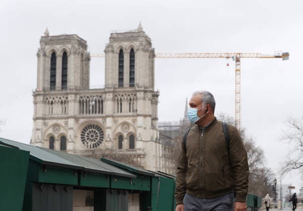 (210317) -- PARIS, March 17, 2021 -- A man wearing a mask walks past the closed Bouquinistes (booksellers of Paris) along the banks of the Seine River in Paris, France, March 17, 2021. France has entered a form of third wave (of the coronavirus pandemic) characterized by numerous virus variants, Prime Minister Jean Castex said on Tuesday, stressing that his government still considers vaccination a top priority of its strategy to stem the spread of the virus. On Tuesday, the health authorities reported 29,975 new infections across the country, bringing the cumulative total to 4,108,108. The number of single-day deaths jumped to 408, taking the total to 91,170. ) FRANCE-PARIS-COVID-19-THIRD WAVE GaoxJing