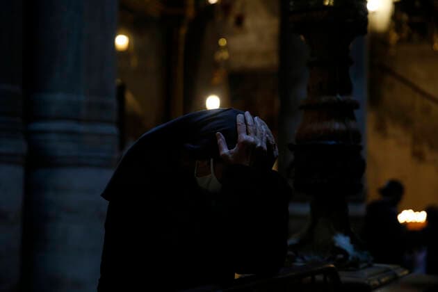 March 25, 2021, Jerusalem, West Bank, Palestinian Territory: Christian worshippers pray inside Church of Holy Sepulcher, amid the coronavirus lockdown, in Jerusalem s Old City, on March 25, 2021. The Palestinian government decided to re-apply the partial closure in the West Bank, with the continued suspension of schools, with the exception of high school students, until April 3 to confront the spread of the Corona virus. The government spokesman said in a statement that it has also been decided that the closure will continue on Friday and Saturday of every week, except for pharmacies and bakeries Jerusalem Palestinian Territory - ZUMAap3_ 20210325_zaf_ap3_099 Copyright: xJamalxAwadx