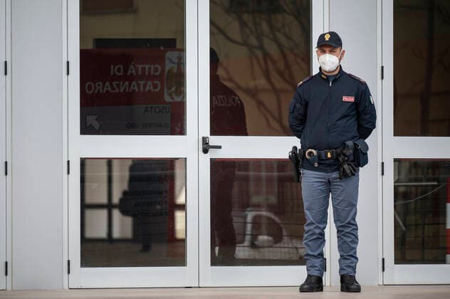 March 26, 2021, Catanzaro, Calabria, Italy: A policeman seen standing in front of the entrance door. Lieutenant general, Francesco Paolo Figliuolo, recently appointed as extraordinary commissioner for the COVID-19 emergency, and Fabrizio Curcio, Head of Department of Civil Protection, visited new vaccination hubs in Calabria. In Catanzaro, in the seacoast district â€oeLidoâ€Â, they visited the new Trade Fair Center selected as potential hub. Sergio Abramo, Mayor of Catanzaro, and Antonino Spirlo¬, and temporary Regional Governor, guided them during the visit. The increasing of vaccination hubs is considered a priority, specially considering the rising number of cases within the region. Catanzaro Italy - ZUMAs197 20210326_zaa_s197_138 Copyright: xValeriaxFerrarox