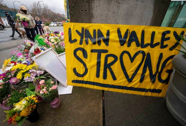 March 28, 2021, North Vancouver, BC, Canada: People lay flowers at a makeshift memorial outside of the Lynn Valley Library in Lynn Valley in North Vancouver, B.C., Sunday, March 28, 2021. A 28-year-old man was charged Sunday with second-degree murder in a stabbing rampage that left a young woman dead and injured six others in and around a library in North Vancouver, B.C., a day earlier. North Vancouver Canada - ZUMAc35_ 20210328_zaf_c35_101 Copyright: xJonathanxHaywardx