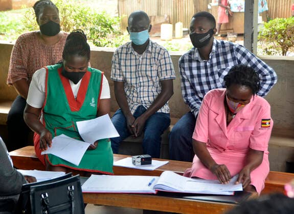 (210331) -- KAMPALA, March 31, 2021 -- Teachers attend COVID-19 vaccination campaign at a health center in Kampala, capital of Uganda, March 31, 2021. Uganda launched the first phase of COVID-19 vaccination campaign on March 10, targeting high risk groups in the east African country. The ministry of health targets to vaccinate more than 21.9 million people who face the highest risk of the infection, which include health workers, teachers, security personnel, elderly and those with underlying medical conditions. (Photo by Xinhua) UGANDA-KAMPALA-TEACHERS-VACCINATION NicholasxKajoba
