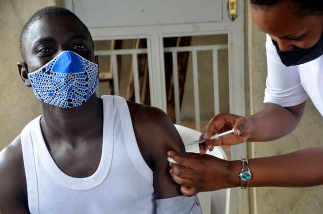 (210331) -- KAMPALA, March 31, 2021 -- A teacher receives a dose of COVID-19 vaccine at a health center in Kampala, capital of Uganda, March 31, 2021. Uganda launched the first phase of COVID-19 vaccination campaign on March 10, targeting high risk groups in the east African country. The ministry of health targets to vaccinate more than 21.9 million people who face the highest risk of the infection, which include health workers, teachers, security personnel, elderly and those with underlying medical conditions. (Photo by Xinhua) UGANDA-KAMPALA-TEACHERS-VACCINATION NicholasxKajoba