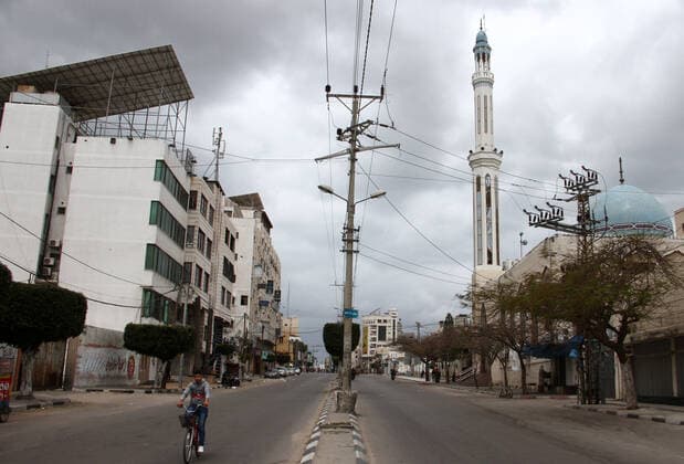 April 10, 2021, Gaza city, Gaza Strip, Palestinian Territory: Paestinians walk at a deserted street is pictured during a lockdown following the outbreak of the coronavirus disease (COVID-19), in Gaza city, on April 10, 2021. New coronavirus cases were down today in the West Bank and Gaza Strip as the death toll remained high. Ministery of Health reported on the disease in Palestine that 438 new cases, 16 deaths, and 812 recoveries were recorded in the West Bank over the last 24 hours, while 1064 new cases, 10 deaths, and 600 recoveries were recorded in the Gaza Strip Gaza city Palestinian Territory - ZUMAap3_ 20210410_zaf_ap3_009 Copyright: xMahmoudxAjjourx