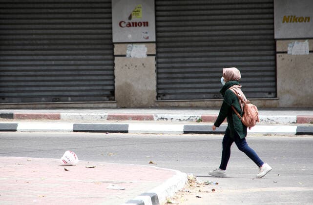 April 10, 2021, Gaza city, Gaza Strip, Palestinian Territory: Paestinians walk at a deserted street is pictured during a lockdown following the outbreak of the coronavirus disease (COVID-19), in Gaza city, on April 10, 2021. New coronavirus cases were down today in the West Bank and Gaza Strip as the death toll remained high. Ministery of Health reported on the disease in Palestine that 438 new cases, 16 deaths, and 812 recoveries were recorded in the West Bank over the last 24 hours, while 1064 new cases, 10 deaths, and 600 recoveries were recorded in the Gaza Strip Gaza city Palestinian Territory - ZUMAap3_ 20210410_zaf_ap3_015 Copyright: xMahmoudxAjjourx