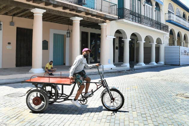 (210416) -- HAVANA, April 16, 2021 -- A man rides a tricycle on the street in Havana, Cuba, April 15, 2021. Cuba registered on Thursday 1,004 new COVID-19 infections in one day, reaching 90,408 cases in total, as well as four more deaths to total 491, the Ministry of Public Health said. (Photo by Xinhua) CUBA-HAVANA-COVID-19-CASES JoaquinxHernandez