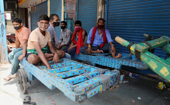 April 18, 2021, New Delhi, India: Cart pullers rest on their hand carts in front of closed shops at Sadar Bazar wholesale market for cosmetic, jewelry, and household items, during the weekend lockdown imposed by the State government to curb the spike of coronavirus (Covid-19) cases. .Only essential services will be exempted from the lockdown, India reported 264,500 new Covid-19 infection cases, 1,501 deaths and 138,423 discharges in last 24 hours. New Delhi India - ZUMAs197 20210418_zaa_s197_060 Copyright: xNaveenxSharmax