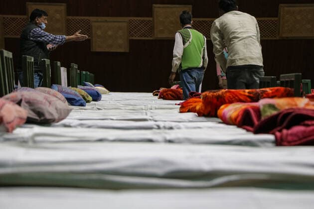 COVID-19: Jammu and Kashmir records 3,164 new cases, 25 deaths SRINAGAR, INDIA, 27 APRIL 2021 - Workers prepare beds at a new makeshift Covid-19 quarantine facility with the capacity of 111 beds inside the Indoor Sports Stadium in Srianagar. After Jammu and Kashmir recorded its highest single-day spike of 3,164 COVID-19 cases, which took the tally to 166,054, while 25 fatalities over the last 24 hours took the toll to 2,197, officials said. SRINAGAR Jammu And Kashmir India Copyright: AdilxAbass
