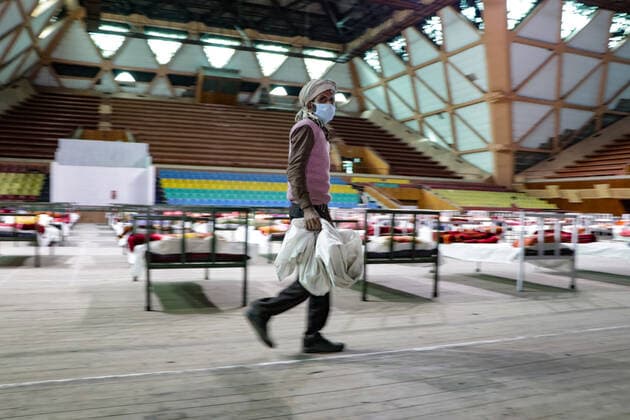 COVID-19: Jammu and Kashmir records 3,164 new cases, 25 deaths SRINAGAR, INDIA, 27 APRIL 2021 - Workers prepare beds at a new makeshift Covid-19 quarantine facility with the capacity of 111 beds inside the Indoor Sports Stadium in Srianagar. After Jammu and Kashmir recorded its highest single-day spike of 3,164 COVID-19 cases, which took the tally to 166,054, while 25 fatalities over the last 24 hours took the toll to 2,197, officials said. SRINAGAR Jammu And Kashmir India Copyright: AdilxAbass