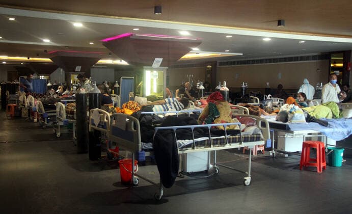 (210428) -- NEW DELHI, April 28, 2021 -- COVID-19 patients are admitted at LNJP hospital in New Delhi, India, April 28, 2021. India s death toll due to COVID-19 surpassed the 200,000-mark, reaching 201,187 on Wednesday, said federal health ministry. As many as 3,293 deaths took place during the past 24 hours, which is the maximum for a daily death record so far this year. Besides, as many as 360,960 new cases were registered since Tuesday morning, taking the total tally to 17,997,267, according to the data released by the federal health ministry. This is the highest single-day spike in COVID-19 cases ever since the pandemic broke out in the country. (Str Xinhua) INDIA-NEW DELHI-COVID-19-PATIENTS stringer