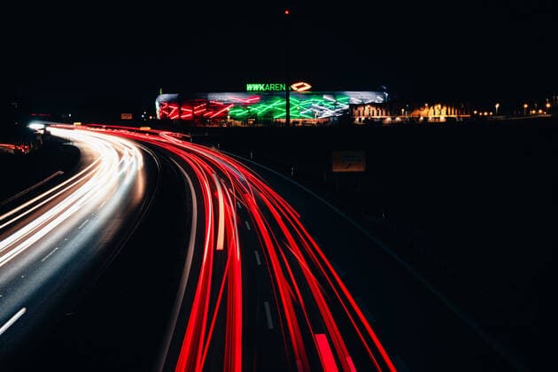 Augsburg, Bavaria, Germany - 25 march 2021: WWK soccer stadium of the Fca at night. traces of light from passing cars at night. the wwk arena is illuminated.