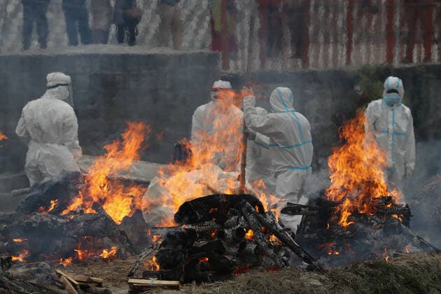 May 4, 2021, Kathmandu, NE, Nepal: Nepal Army personnel and workers in full personel protective equipment (PPE) gear cremate multiple Covid-19 on the bank of the Bagmati river at Pashupati, Kathmandu, Nepal, May 4, 2021. According to the Ministry of Health and Population, 55 people died of Covidâ€19 in the last 24 hours whereas more than 7,000 new cases were recorded across the country. Kathmandu Nepal - ZUMAd164 20210504_zip_d164_001 Copyright: xAryanxDhimalx