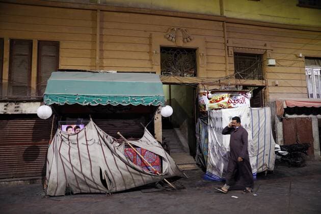 (210506) -- CAIRO, May 6, 2021 -- A man walks past closed booths at a night market in Cairo, Egypt, on May 6, 2021. Egyptian Prime Minister Mostafa Madbouly on Wednesday announced two-week new precautionary measures to control the spread of the COVID-19. Madbouly said in a televised press conference that restaurants, cinemas, shops, malls, clubs and entertainment facilities will be closed at 9 p.m. local time (1900 GMT) for two weeks starting the evening of Thursday, just ahead of the end of the Islamic holy month of Ramadan and the feast festival Eid al-Fitr. ) EGYPT-CAIRO-COVID-19-MEASURES AhmedxGomaa
