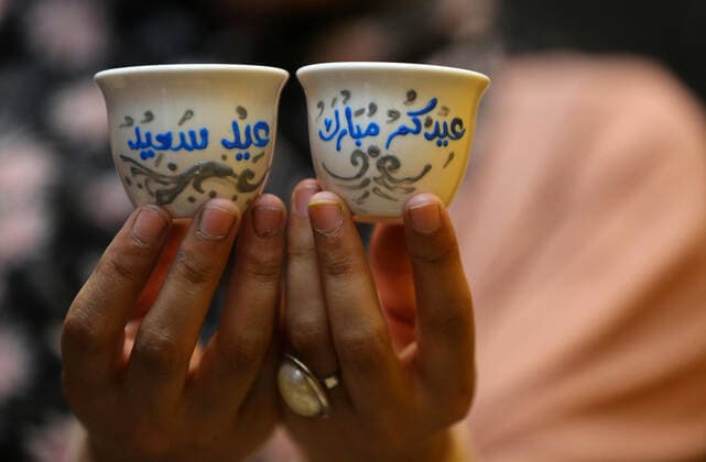 May 8, 2021, Maghazi, Gaza Strip, Palestinian Territory: Palestinian artist, Abeer Al-Tallaa, 23, paints on the pots and cups of coffee the congratulatory phrases for Eid Al Fitr, at Maghazi refugee camp in the center of the Gaza Strip, on May 8, 2021. People flock markets and shopping malls as they shop for food and new clothings in preparation for Eid al Fitr holiday that marks the end of Ramadan, the holiest month in Islamic calendar Maghazi Palestinian Territory - ZUMAap3_ 20210508_zaf_ap3_028 Copyright: xAshrafxAmrax