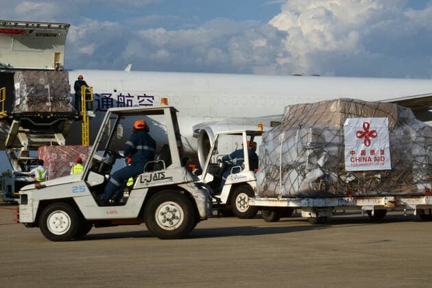 (210511) -- VIENTIANE, May 11, 2021 -- Workers transport anti-epidemic material supplies donated by the Chinese government at Wattay International Airport in Vientiane, Laos, May 10, 2021. The Chinese government-donated anti-COVID-19 material supplies have arrived at Wattay International Airport in Lao capital Vientiane with a handover ceremony held upon their arrival. The Chinese government s emergency assistance to Laos includes ventilators, automatic nucleic acid extractors, medical masks, N95 masks, mobile hospital beds, automatic autoclaves, nucleic acid extraction or purification reagents, and nucleic acid detection kits, etc. ) LAOS-VIENTIANE-CHINA-ANTI-EPIDEMIC SUPPLIES-DONATION-ARRIVAL ZhangxJianhua