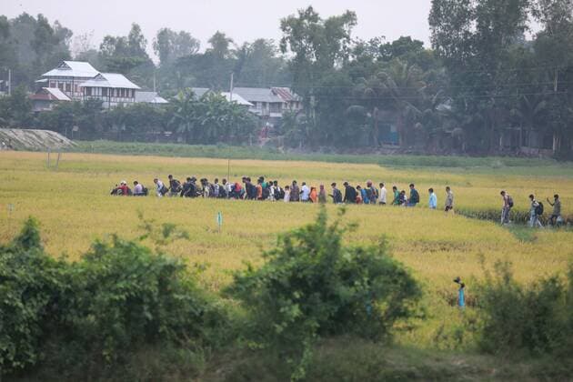 May 12, 2021, Dhaka, Dhaka, Bangladesh: May, 12, 2021 Bangladeshi homebound people walk through paddy field as they on the way to the Shimuliya ferry terminal, in Shimuliya, Munshiganj, on the outskirts of Dhaka, Bangladesh, May 12, 2021. Five people died after they fell sick due to the heat on two overcrowded ferries in Madaripur s Banglabazar today. Eight others fell ill at the same time this noon. Dhaka Bangladesh - ZUMAr338 20210512_zip_r338_078 Copyright: xHarun-Or-Rashidx