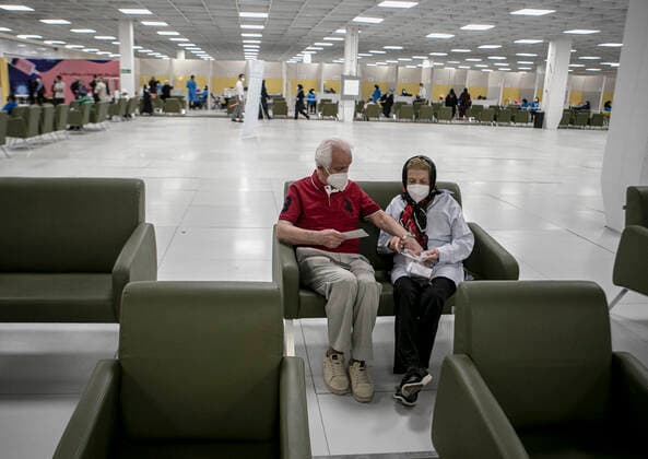 (210517) -- TEHRAN, May 17, 2021 -- People wait to receive the COVID-19 vaccine at a vaccination site in Tehran, Iran, on May 17, 2021. Iran reported on Monday 14,319 new COVID-19 cases, raising the country s total number to 2,765,485. By Monday, 2,032,162 people have received the first doses of coronavirus vaccines and 388,821 the second doses. (Photo by Xinhua) IRAN-TEHRAN-COVID-19-VACCINATION AhmadxHalabisaz