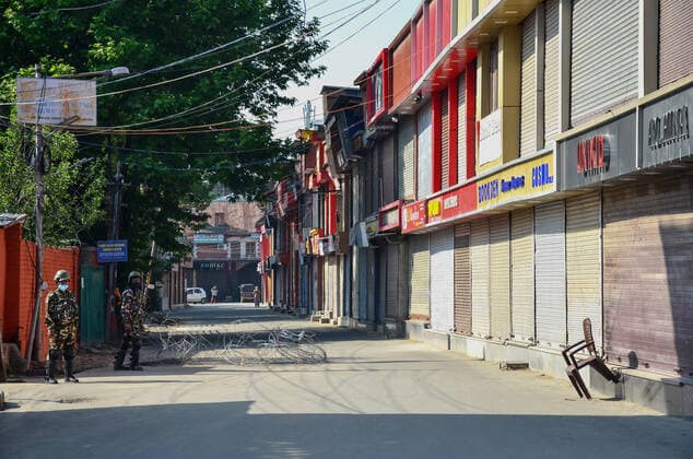 May 18, 2021, Srinagar, Jammu & Kashmir, India: Paramilitary troopers stand guard at a closed market during a Coronavirus curfew imposed following the surge in COVID-19 cases in Srinagar. With the increasing number of COVID-19 cases in Jammu and Kashmir, the government has decided to extend the Coronavirus Curfew till May 25. .Jammu and Kashmir reported highest ever single day spike in the number of COVID-19 deaths as 73 persons succumbed to the virus. Also, 3,344 new COVID-19 cases have been reported, in last 24 hours. Meanwhile, India saw another grim record with 4,329 COVID-19 patients dying in the last 24 hours even as daily cases dropped to 263,000. Srinagar India - ZUMAs197 20210518_zaa_s197_007 Copyright: xSaqibxMajeedx